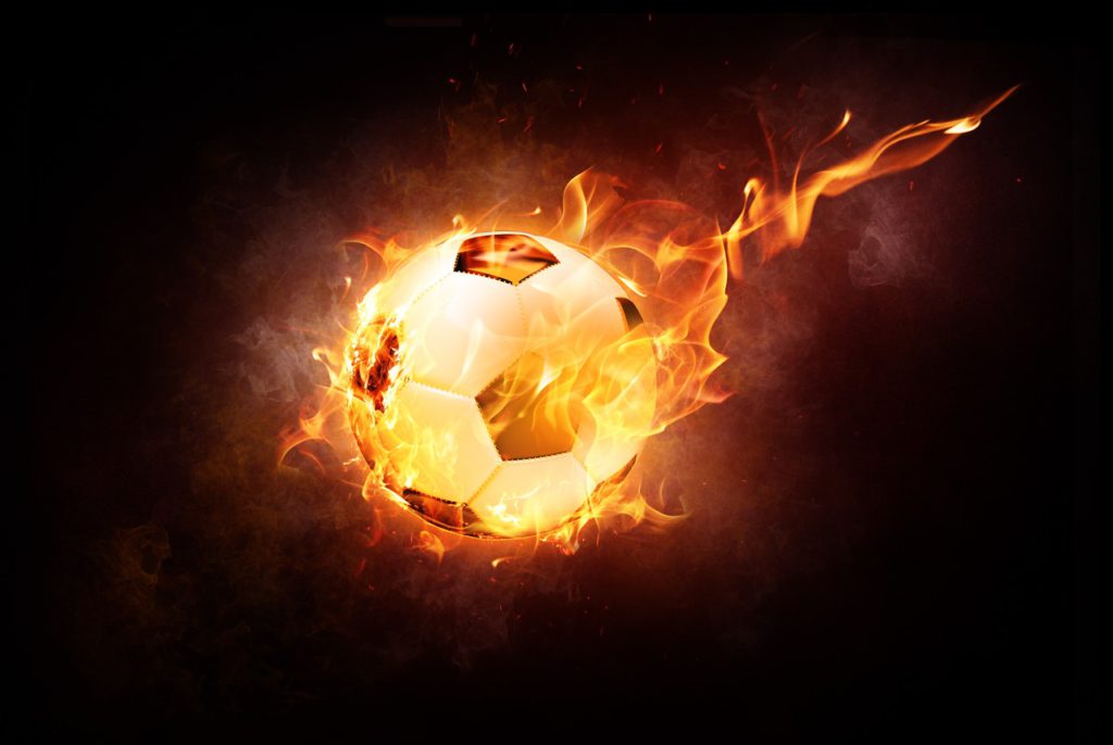 En brinnande fotboll som flyger genom luften.